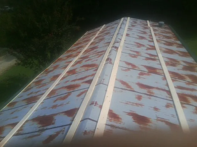 Rusted metal roof panels with new wood purlins before replacement — Storm Damage Roof Repair in Rockwood by Roofing Brothers