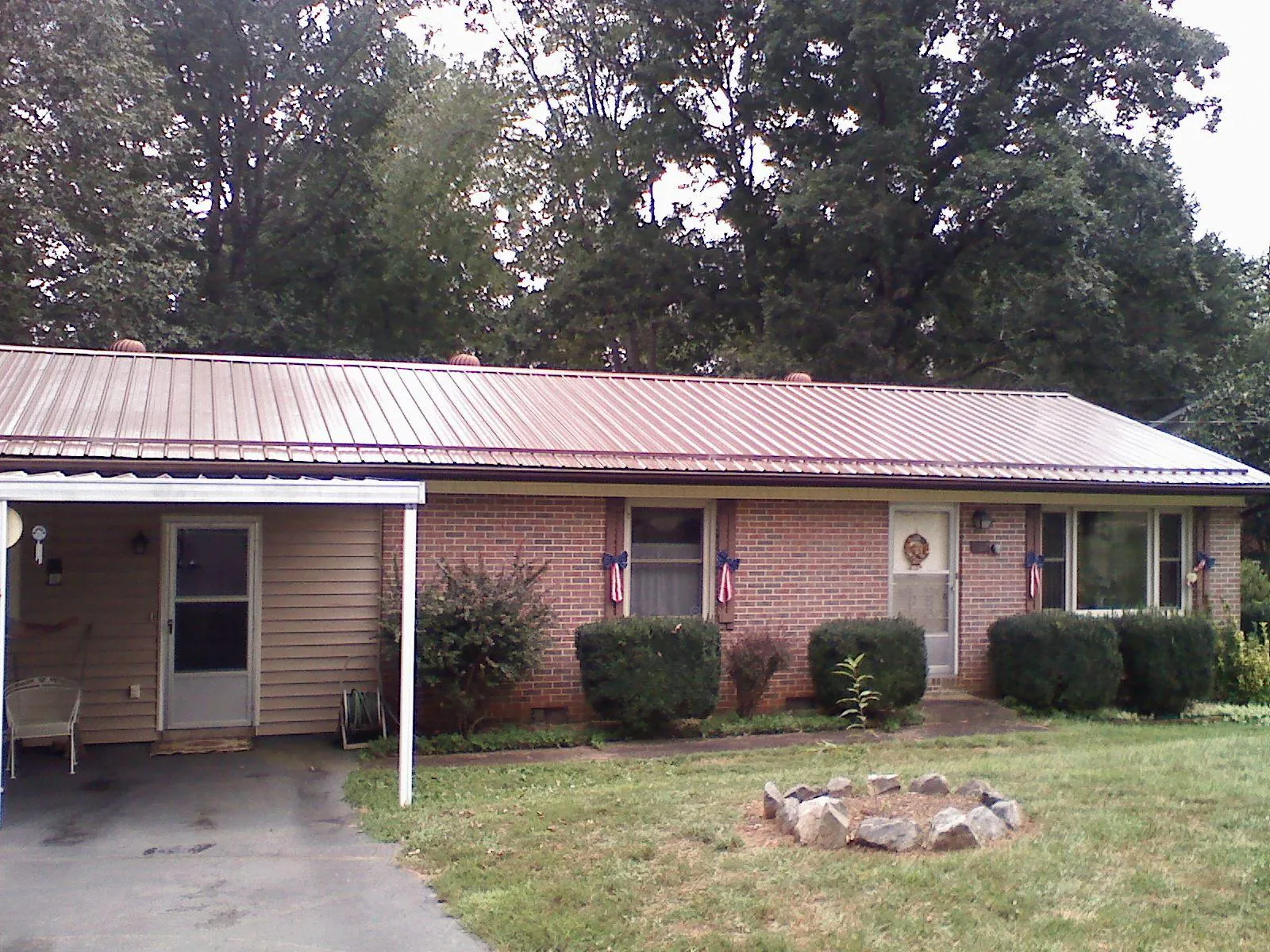 Bronze metal roof and carport on a brick ranch home — Roof Repair work by our crew in Rockwood