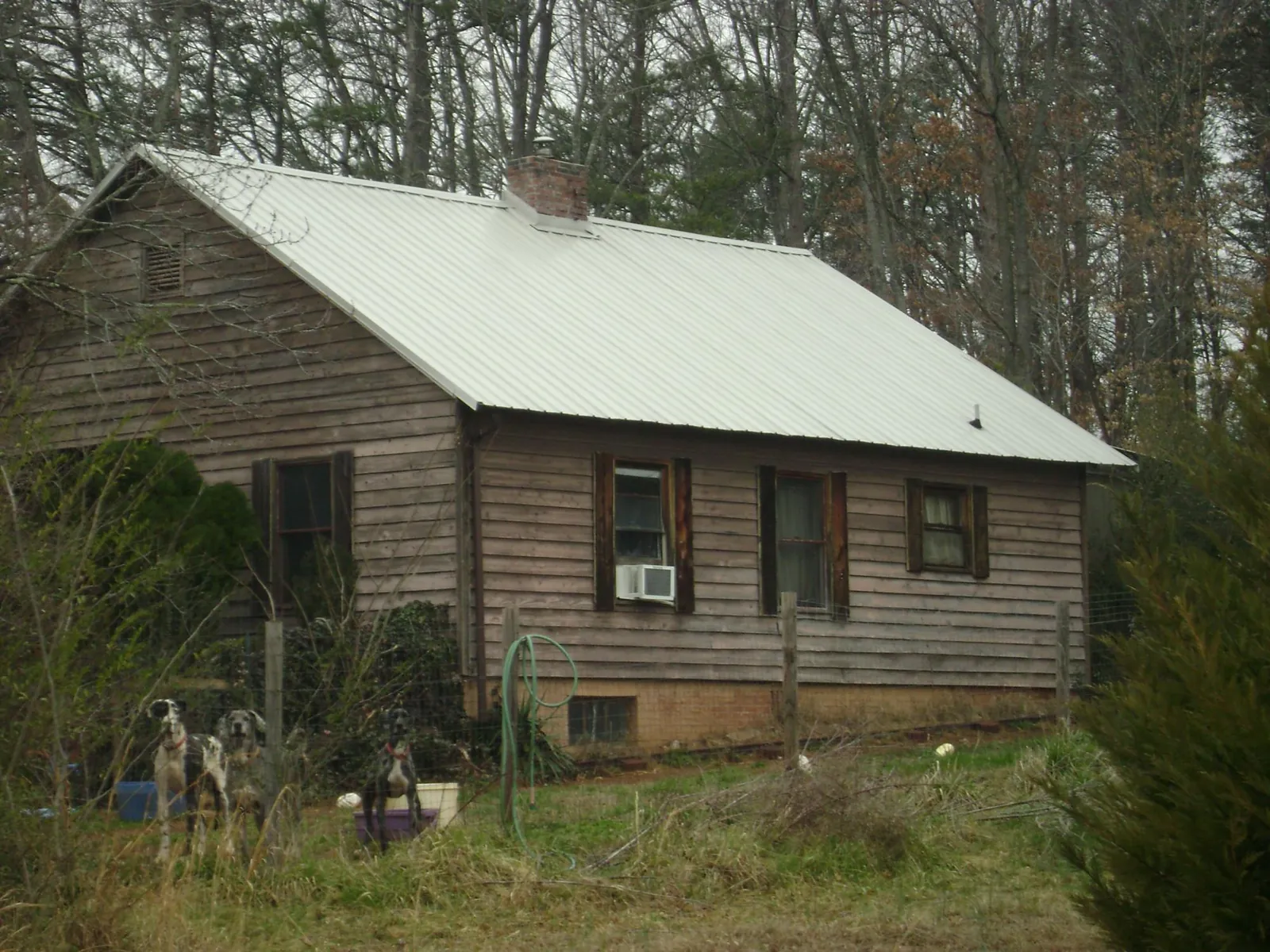 White metal roof on an old wood sided farmhouse, from a Metal Roof Installation job in Rockwood